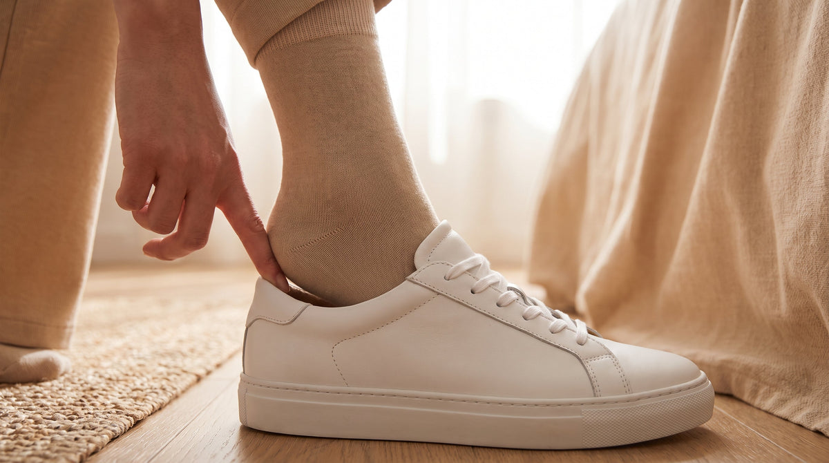 KANEEA heel grip pad being placed inside sneaker heel counter — stops slipping in seconds