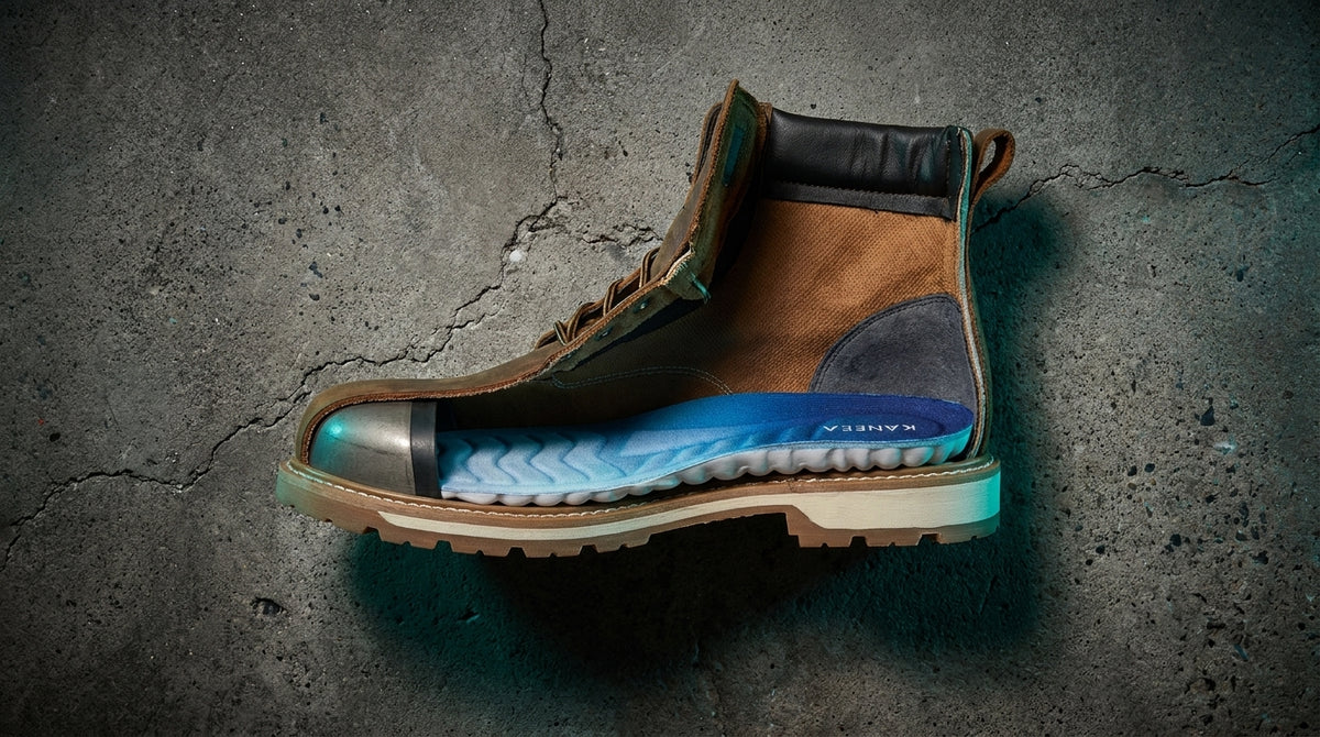Steel-toe work boot cut open revealing KANEEA insole inside showing arch support and cushioning layers