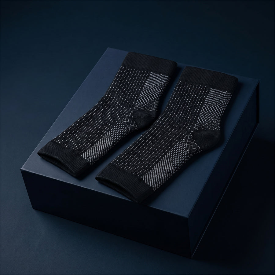 KANEEA black toeless compression ankle sleeves on navy box