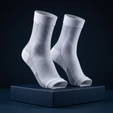 KANEEA compression ankle sleeves pair standing on navy box