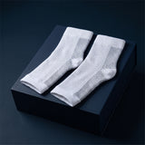 KANEEA white toeless compression ankle sleeves on navy box