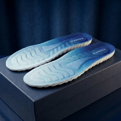KANEEA memory foam insoles with blue gradient design, 
placed on navy blue premium packaging box